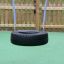 Single Swing - black tire swing hanging on blue ropes in a playground.