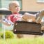 A child enjoying a ride on Single Swing playground equipment.