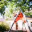 Playground equipment Single Swing with orange and gray frame.