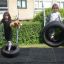Children playing on Double Swing tire swings in a playground.
