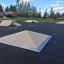 Concrete skateboard ramps in an outdoor skate park.