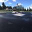 Skate park with ramps and obstacles on an asphalt surface, featuring the Corner product.