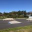 Outdoor skate park with ramps and benches, featuring the Corner product.