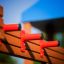 Wooden play structure with red handles from Tritowers castle with slide.