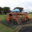 Children playing on Tritowers castle with slide in a park.