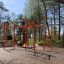 Outdoor fitness structure New Age Fit MEDIUM in a park setting.