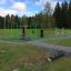 Outdoor fitness park with various green exercise equipment in New Age Fit.