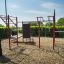 Outdoor fitness station New Age Fit with various workout equipment.