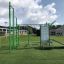 Outdoor fitness station New Age Fit with various workout equipment in a park setting.