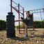 Man practicing kicks on New Age Fit outdoor fitness equipment.
