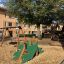 Green double slide with dragon design on a playground