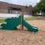 Playground slide in the shape of a dragon back.