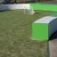 Outdoor soccer field with green and white curved walls and a small goal, part of the Multiarena.