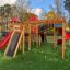 Space Station castle with slide in a playground setting.