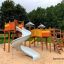 Outdoor playground structure: Space Station castle with slide for children.