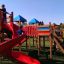 Children playing on the Space Station castle with slide.