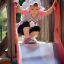 Child sliding down a playground slide.