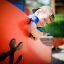 Boy playing on Fisher Boat Ship Sandbox structure in playground.