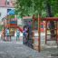 Chimpanzee wooden playhouse with slide and climbing wall in playground.