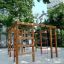 Chimpanzee wooden playhouse in a playground surrounded by trees.