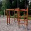 Chimpanzee wooden playhouse in a playground surrounded by trees.