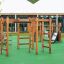 Chimpanzee wooden playhouse climbing structure on playground with green safety surface