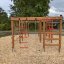Wooden outdoor playhouse with climbing features for children