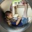 Train: Girl playing inside playground tunnel