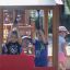 Children playing on a train-themed playground structure.