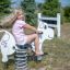 A child on a Cow rocking spring rider at a playground.