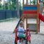 Child riding a Mini Tractor rocking at playground.