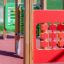 Memory playground equipment with wooden posts and red and green activity panels.