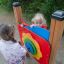 Children playing with Clock playground panel.