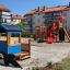 Outdoor playground with Villa with Orca single playhouse and red slide tower in residential area.