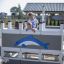 Children playing on Small Ship with Dolphin playground structure.