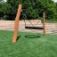 Wooden playground swing 'BNS Single Swing Robinia 2 Posts' on grass.