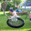 Child swinging on BNS Single Swing Robinia 2 Posts at a playground.