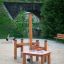 Sand & Water Play playground equipment made of wood with sand and water tables on a sandy surface.
