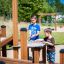 Children playing at the Sand & Water Play Nature structure.
