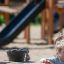 A child playing with Sand & Water Play Nature equipment at playground.