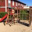 Playground Climbing Kiosk (Wide Slide) at a sandy play area with a wooden structure, rope climbing n