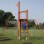 Child climbing on Mast climbing net structure in playground.