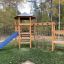 Six Angle with Suspension Bridge single slide at a playground in a forest setting.