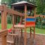 Wooden Six Angle with Suspension Bridge single slide in a playground.