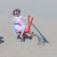Child playing on red Excavator playground equipment in sandbox