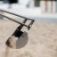 Excavator digging in sand.