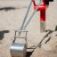 Metallic Excavator toy on a sandy playground.