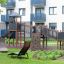 Explorer castle with slide wooden playground structure with climbing wall and bridge outdoors