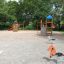 Logo Tower with Firepole playhouse with slide in a playground.