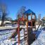 Logo Tower with Firepole playhouse with slide in a snowy playground